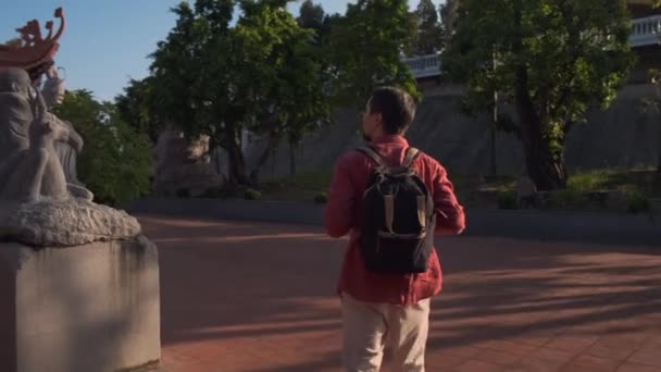 El turista está disfrutando de un paseo por el territorio del templo budista — Vídeo de stock