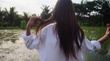 Meçhul kadın yeşil pirinç tarlasında yürüyor.