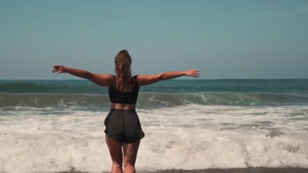 Woman is running into ocean waves, human and nature — Stock Video