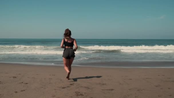 Jogger is enjoying jogging on ocean beach — Stock Video