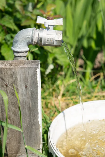 from the watering tap water flows out