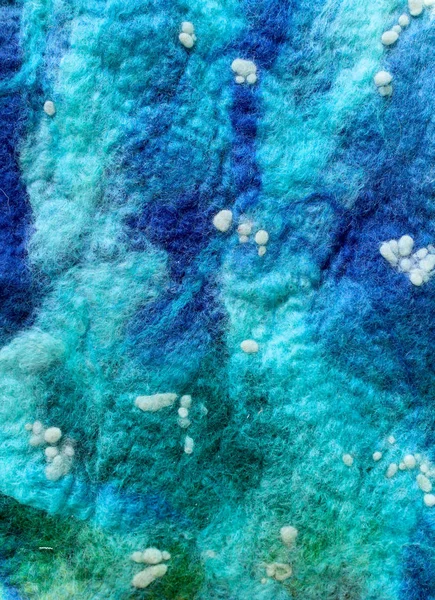 Background wool felted for decoration. Warm wool for felting and decor
