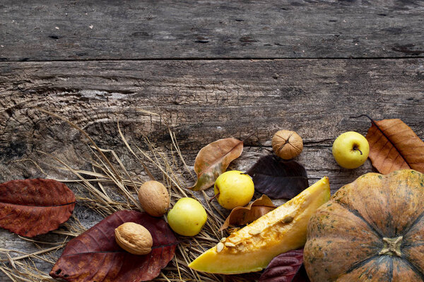 thanksgiving concept. Autumn composition with dry leaves and ripe pumpkins on a dark wooden table. Top view. Copy space. Rustic natural style background for thanksgiving day. autumn harvest concept.