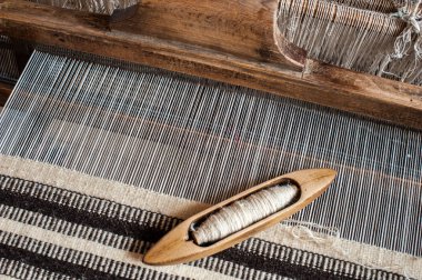 Hungarian homespun weaving. Traditional weaving hand-loom for carpets in Transylvania. clipart