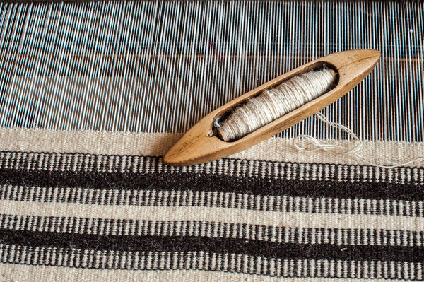 Hungarian homespun weaving.Traditional weaving hand-loom for carpets in Transylvania. Weaving background.