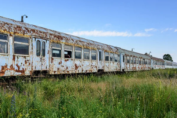 Old rusty railway wagon whit broken windows. Old abandoned track, siding with dirty old trains. Old railway tracks.