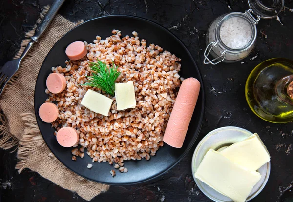 Porridge di grano saraceno con salsiccia e burro. vista dall'alto. — Foto Stock