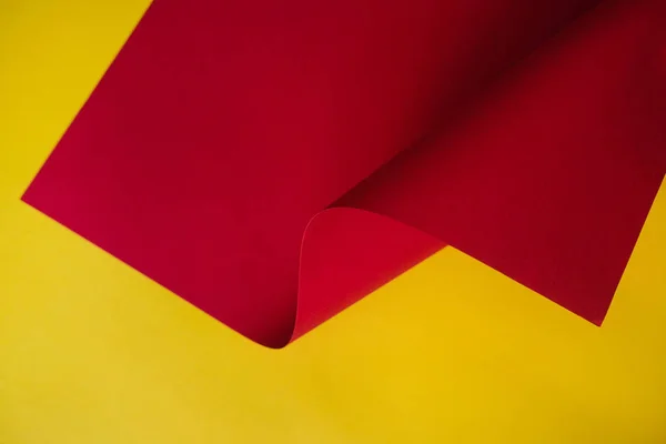 Abstraction of a design paper red and yellow. Empty space on monochrome paper.
