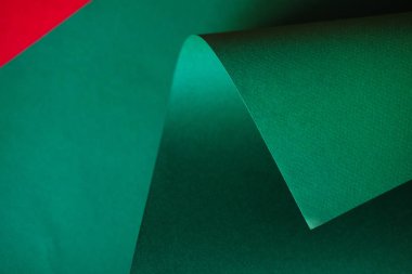 Parlak yeşil yaprak kağıt üzerinde kırmızı bir arka plan. Tek renkli renk kağıt tasarımı.    