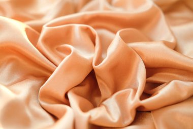 Kumaş altın dalgalar - arka plan ve doku için malzeme. Kumaş kadar kapatın.    