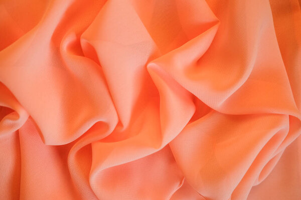Fabric peach waves - material for background and texture. Close up fabric.