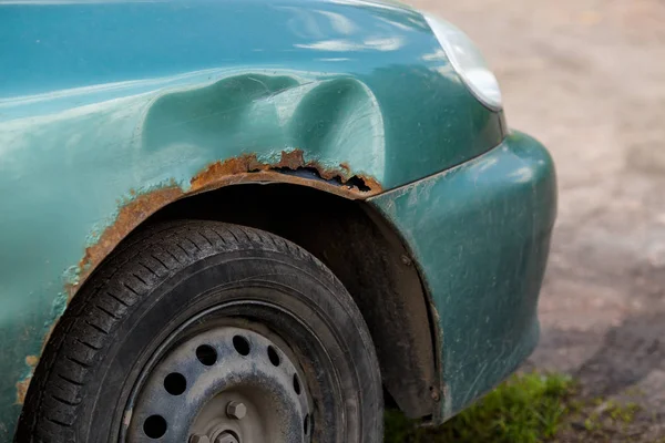 Rusty right wing of car with corrosive defect. Corrosion and rust