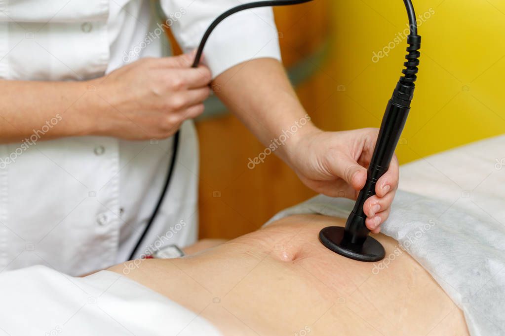 Woman getting anti cellulite therapy in beauty salon. RF lifting