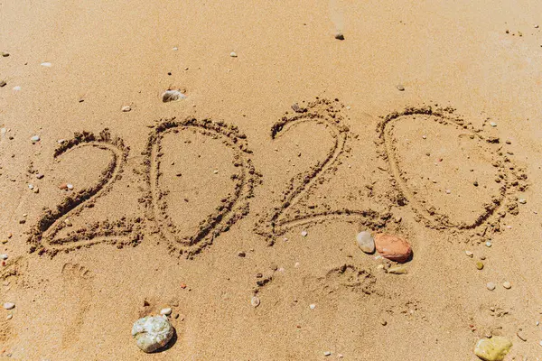 2020 number handwritten lettering on sand of sea beach — Stock Photo, Image
