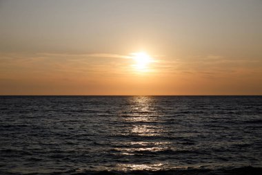 Dalgalar ve güneş yansıması ile karanlık deniz yüzeyi