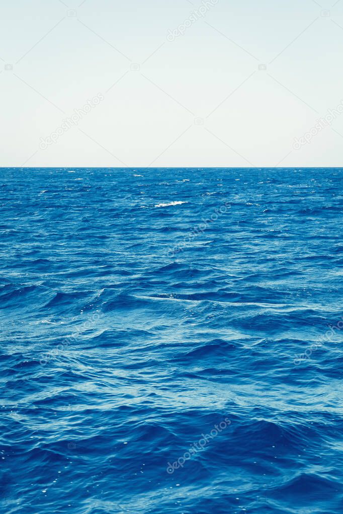 Blue sea surface with waves and horizon