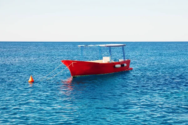 Empty touristic or fishing boat on turquoise sea surface — Stock Photo, Image