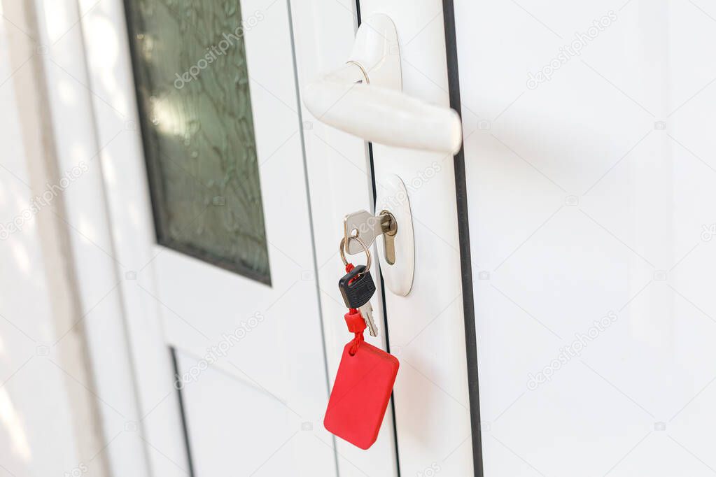 White plastic handle, lock and key of house door