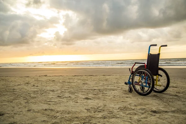 sunset childlike wheelchair horizon sand
