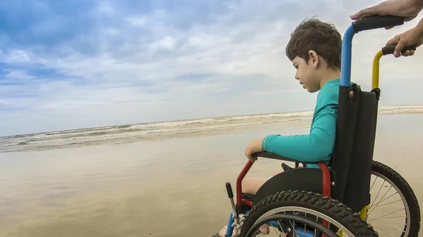childlike wheelchair horizon sand foot