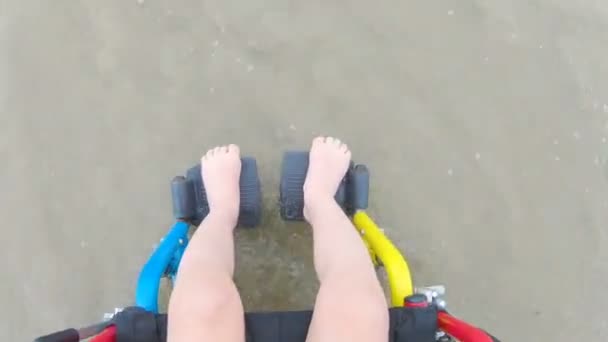 Childlike wheelchair horizon sand — Stock Video