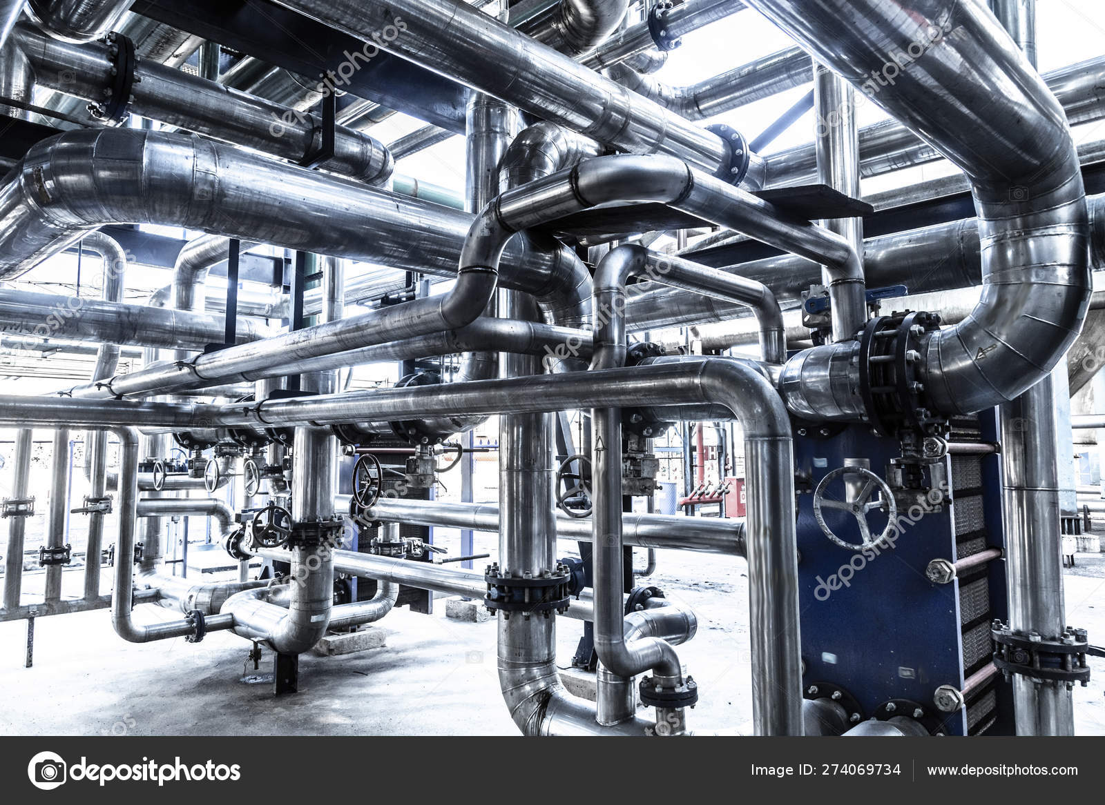 Industrial steam pipe with valves and stainless steel actuators Stock