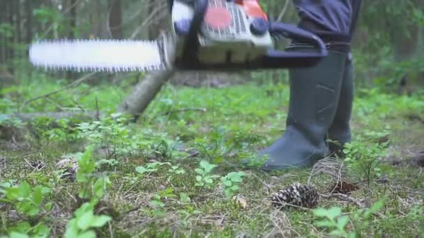 Man in the uniform sawing wood chainsaw — Stock Video