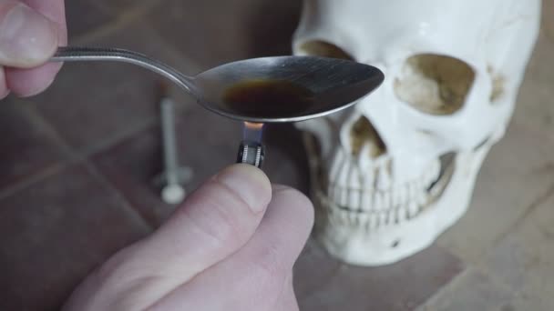 In preparing spoon dose of the drug. skull background. Close up — Stock Video