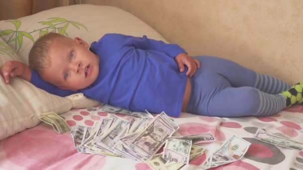 Schlafendes Baby und fallendes Geld. Konzept unerwarteten Reichtums. Ein großer Gewinn. — Stockvideo