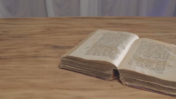 Open old vintage book is on the table — Stock Video