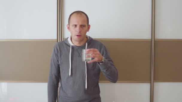 Sick man coughs, blows his nose and drinks medicine — Stock Video