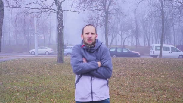 Kranker Mann fröstelt wegen kaltem Herbst oder Herbstwetter im Freien oder in der Stadt wegen Grippevirus. — Stockvideo