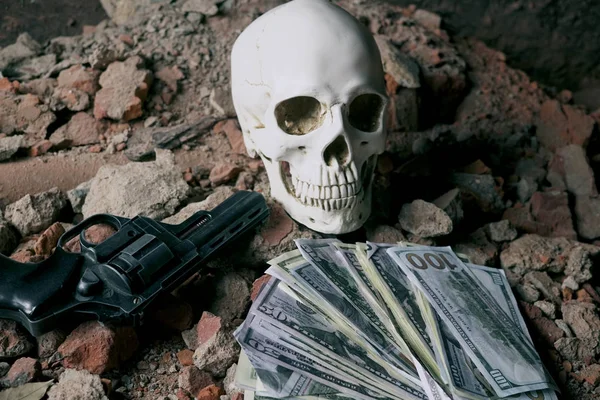 Money and a revolver near the skull. Criminal concept Royalty Free Stock Images