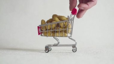 Shopping cart from the supermarket filled with peanut nuts.