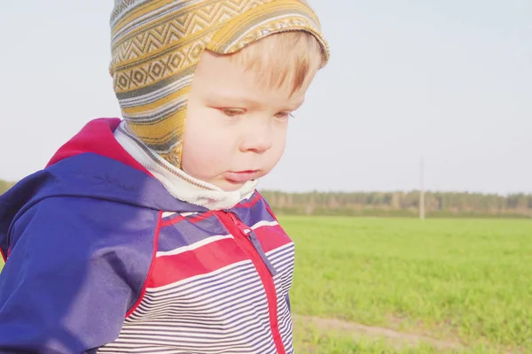Um ano de idade menino agricultor de pé no campo com trigo jovem — Fotografia de Stock