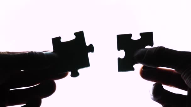 Puzzle in hands isolated on white background — Stock Video