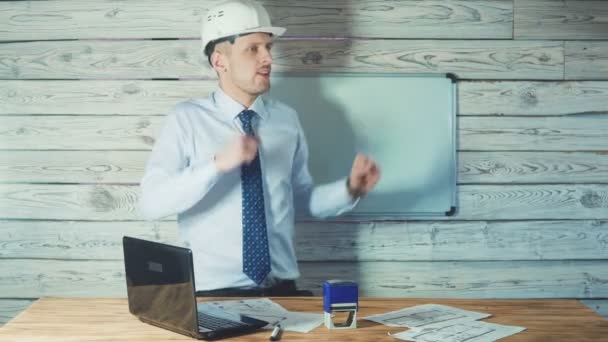 Dacing man in a suit with a security helmet. Concept on success in the construction business. — Stock Video