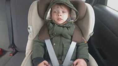 Arabanın arka koltuğunda küçük bir çocuk uykuya dalın. Araba kötü bir yola gidiyor. Bebek ile seyahat