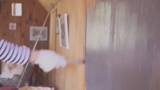 Worker paints a wooden attic. Wood surface treatment. — 비디오