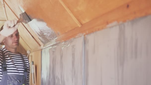 Worker paints a wooden attic. Wood surface treatment. Closeup portrait — 비디오