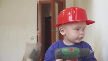 Genç Sevimli Oluşturucusu çocuk tek tip ve sabit hat veya kask ile inşaat ve onarım arka planı Elektrikli tornavida.