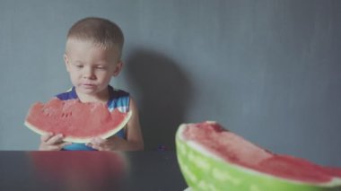 Mutlu gülümseyen çocuk iştah açıcı kırmızı karpuz ve meyve suyu ağız altında akan yeme