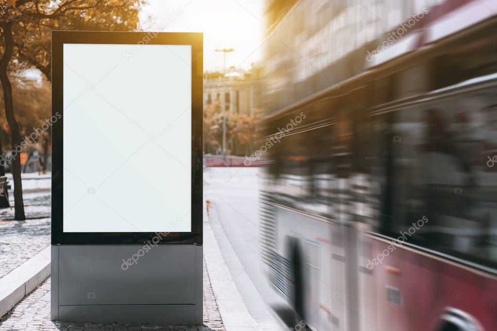 A tourist double-decker is passing by at a high speed near empty urban billboard mockup; two-decker full of tourists near the bus stop with the template of clean city information banner placeholder