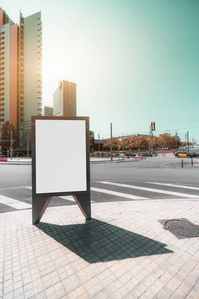Vertical view of an outdoor empty informational board placeholder with a road junction behind; a blank advertising banner template with the crossroad behind; white blank urban billboard mockup