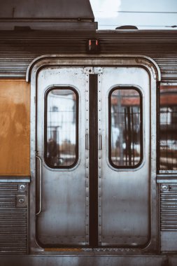 Windows, açılış, sapları ve bir yuvarlak kilit için iki düğme ile Avrupa bir banliyö treninin krom taşıma metal grungy kapalı otomatik kapılar dikey atış kırpmak