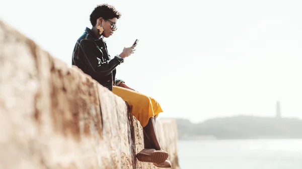 携帯電話を持つ岸壁の女の子 — ストック写真