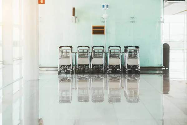 Rows of baggage carts indoors — Stock Photo, Image