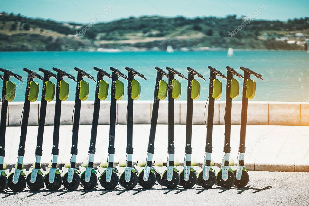 An outdoor row of electric scooters