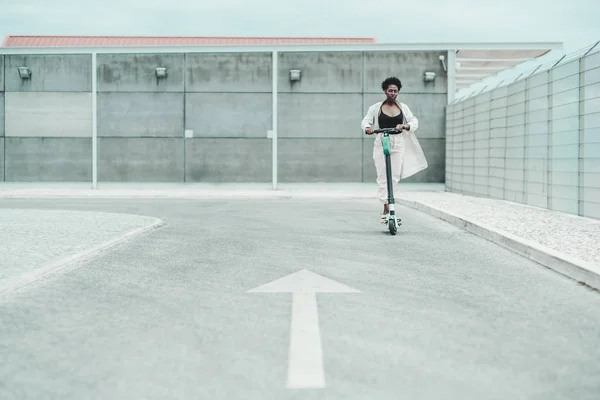 Black girl is riding an e-scooter — Stock Photo, Image