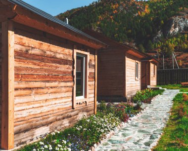 Wooden cabins in the mountain clipart